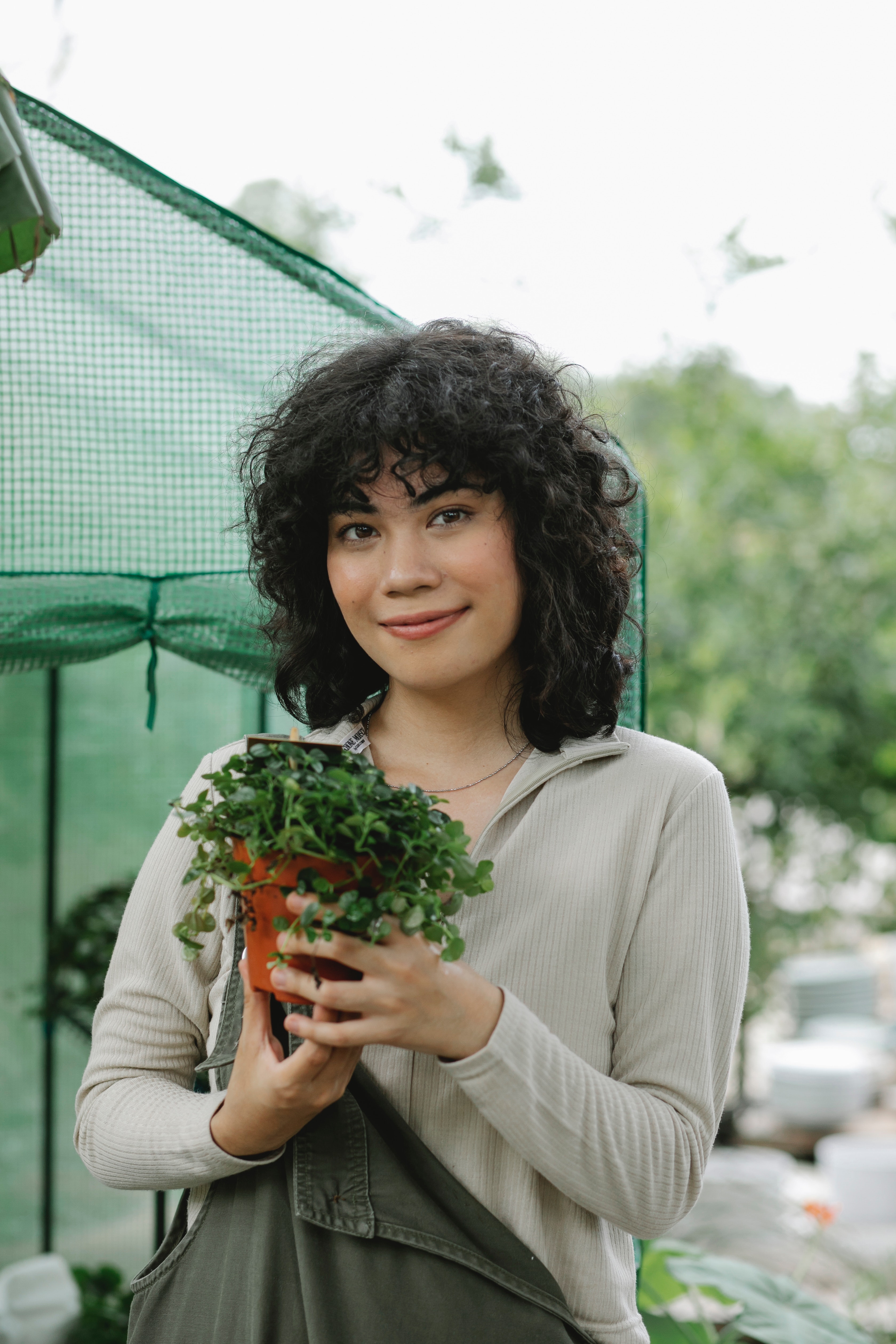 a woman holding a green plant